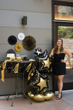 Blackgold foil balloon featuring a star cluster design from Anagram, perfect for celebrations and festive decorations.