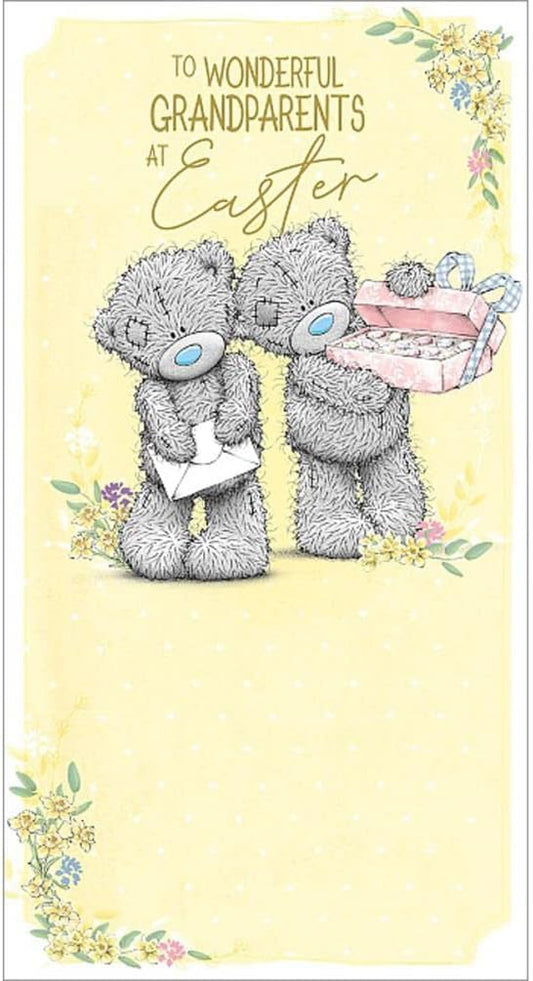 Grandparents bear figurine holding a letter and basket of eggs, crafted by Carte Blanche, with detailed facial features and cozy clothing.