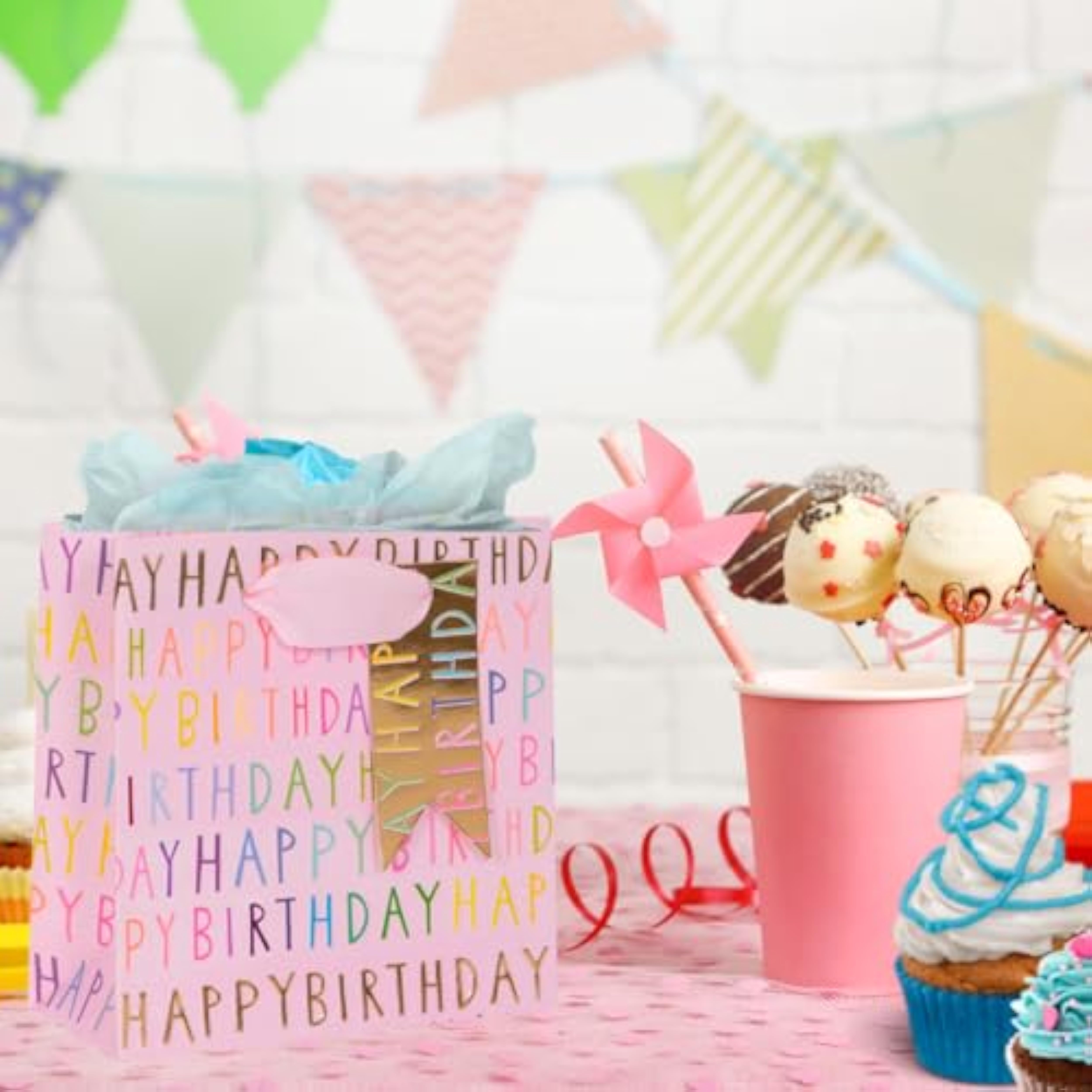 Pink luxury gift bag with "Happy Birthday" design from GLK, featuring elegant handles and decorative details.
