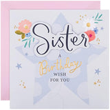 Hallmark birthday greeting card for sister featuring a floral and star design with colorful illustrations.