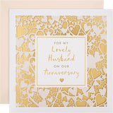 Gold laser-cut Hallmark anniversary greeting card featuring intricate heart designs for husbands.