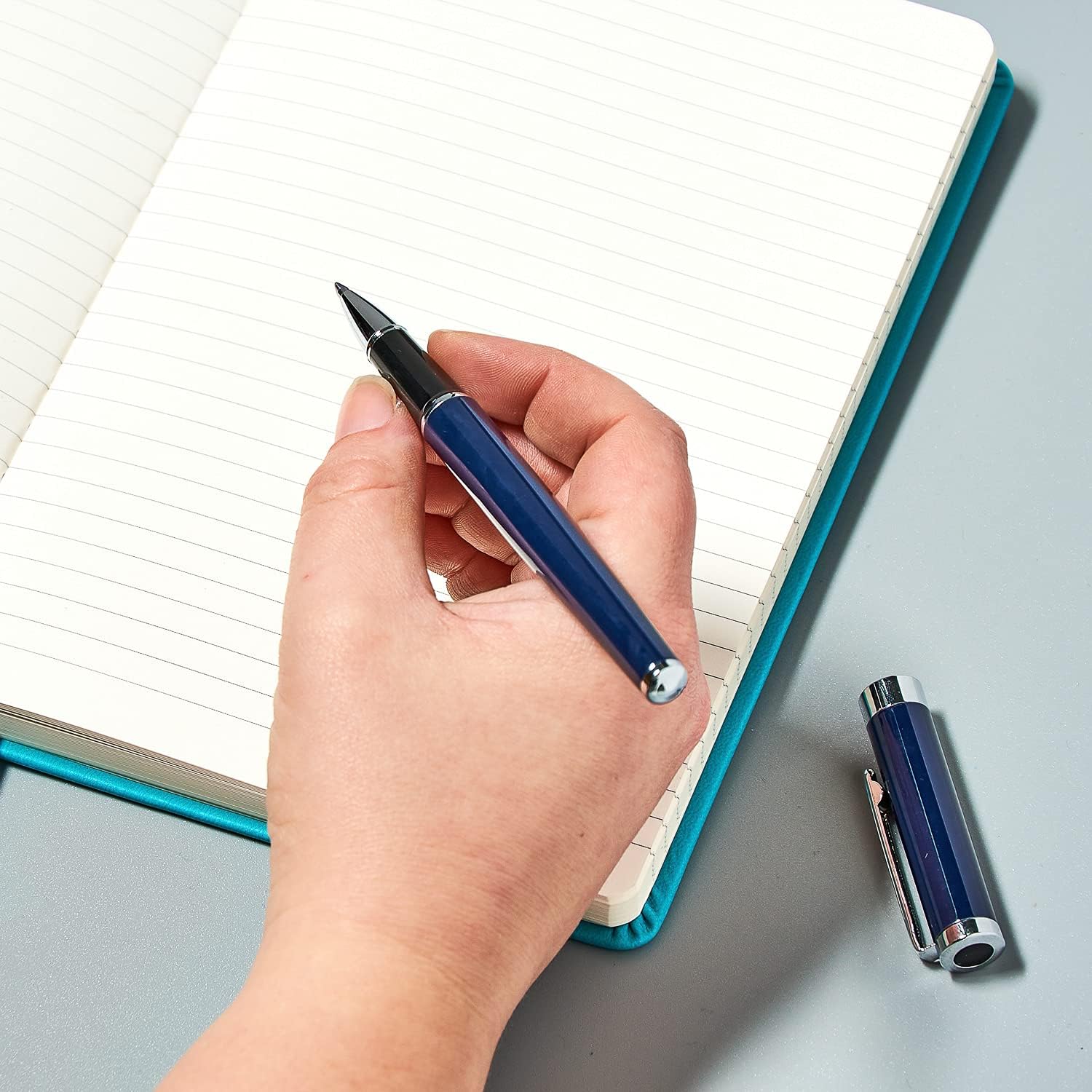 Helix Oxford Premium Rollerball Pen with blue ink, shown in plastic-free packaging, featuring a sleek design and smooth writing tip.