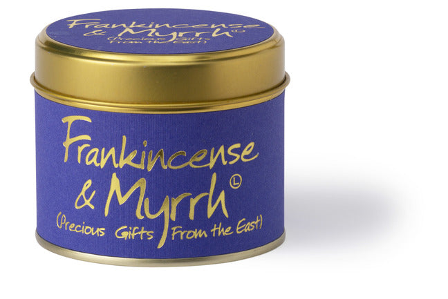 Lily-Flame frankincense and myrrh scented tin candle with a decorative label and warm, inviting glow.