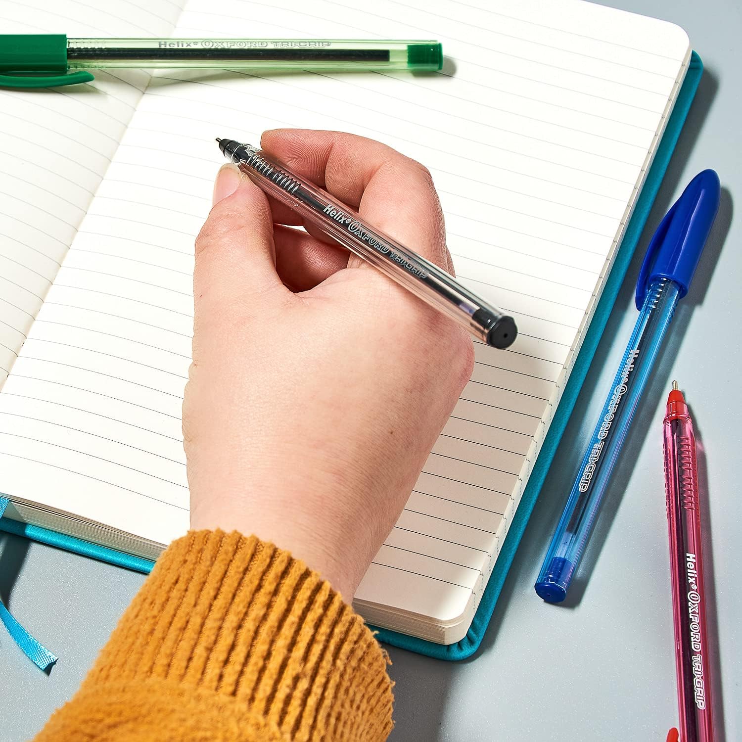Set of 10 Oxford Trigrip pens in assorted colors, featuring ergonomic grip for comfortable writing.