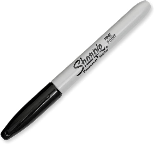 Sharpie black permanent marker fine point next to a greeting card, showcasing its precise tip for detailed writing or decorating.