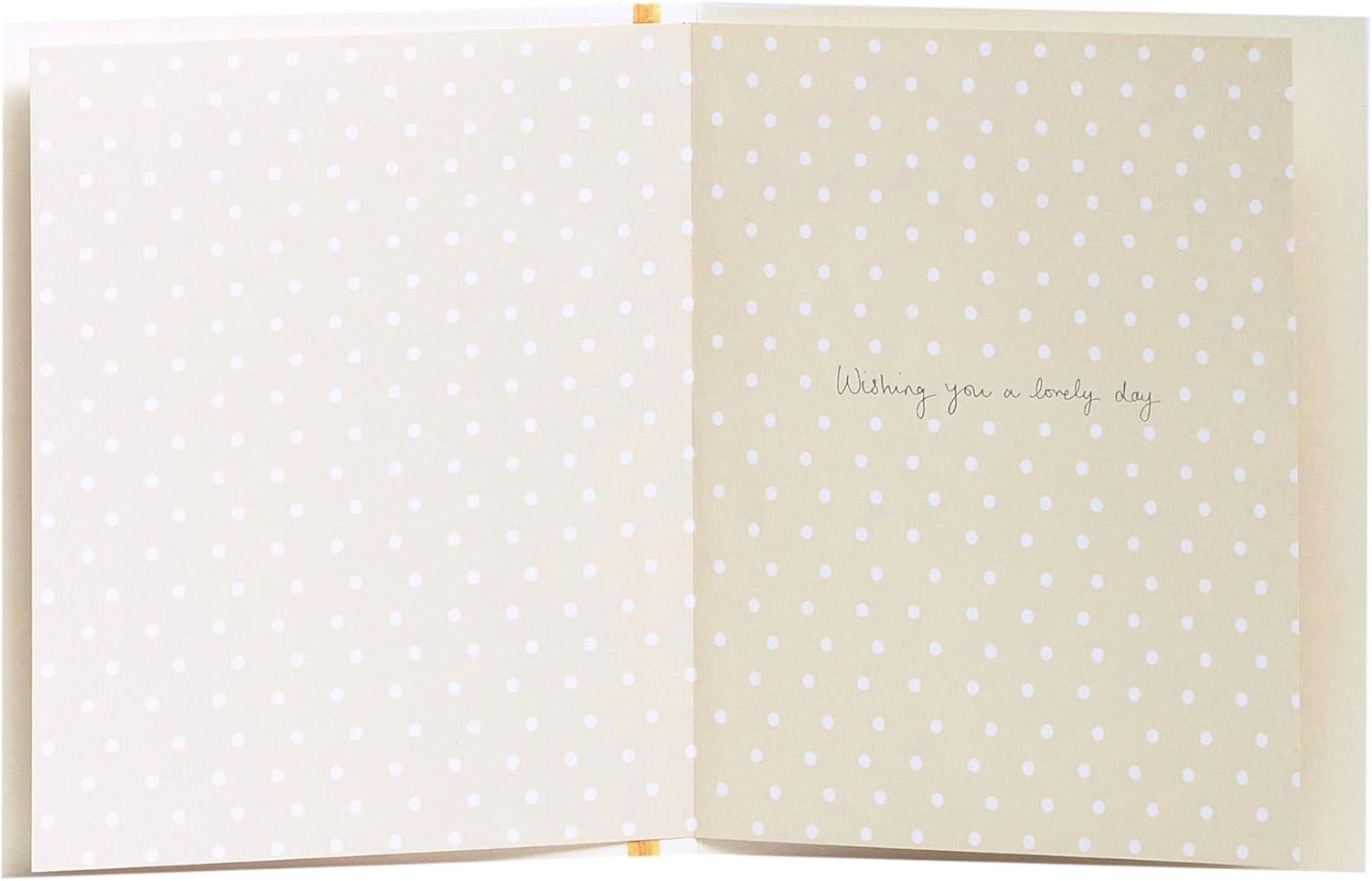 Mother holding a heartfelt Christening card from UK Greetings, featuring a delicate design for a baby's special day.