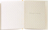 Mother holding a heartfelt Christening card from UK Greetings, featuring a delicate design for a baby's special day.