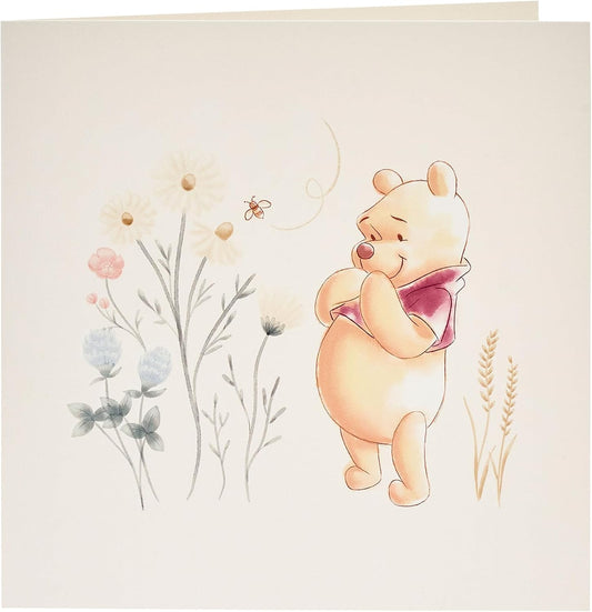 UK Greetings Disney Winnie the Pooh gift wrap, greeting card, and tag bundle featuring colorful Pooh-themed wrapping and accessories.
