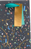 Festive party popper bottle gift bag with colorful holiday design, ideal for gift packaging from UK Greetings.