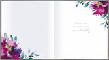 Pastel floral 70th birthday greeting card by UK Greetings featuring colorful floral illustrations and celebratory design.