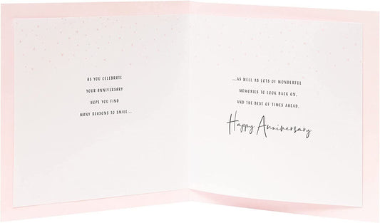 A greeting card from UK Greetings featuring a romantic design for a couple's anniversary celebration.