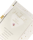 Beautifully designed UK Greetings husband anniversary greeting card with heartfelt message and elegant floral details.