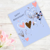 Gold embossed Braille Happy Anniversary greeting card with floral design from UK Greetings, featuring both tactile Braille and printed message.