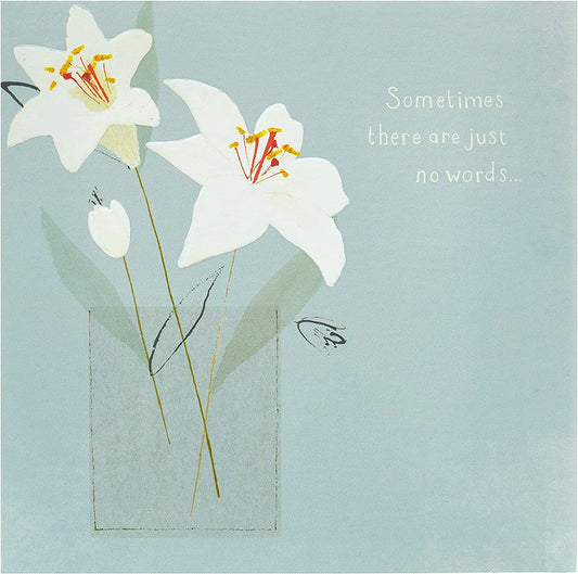 Elegant lilies sympathy greeting card by UK Greetings featuring a floral design suitable for conveying condolences.