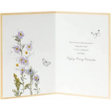 Embossed floral birthday greeting card with meadow design from UK Greetings featuring colorful flowers and intricate details.