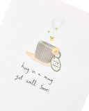 Get Well Soon greeting card featuring a handmade design with a cozy mug and hug illustration, perfect for UK Greetings.