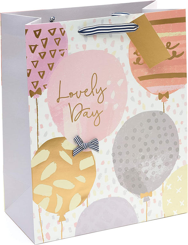 Large golden birthday gift bag from UK Greetings with balloon and greeting card design, perfect for celebratory gift presentation.