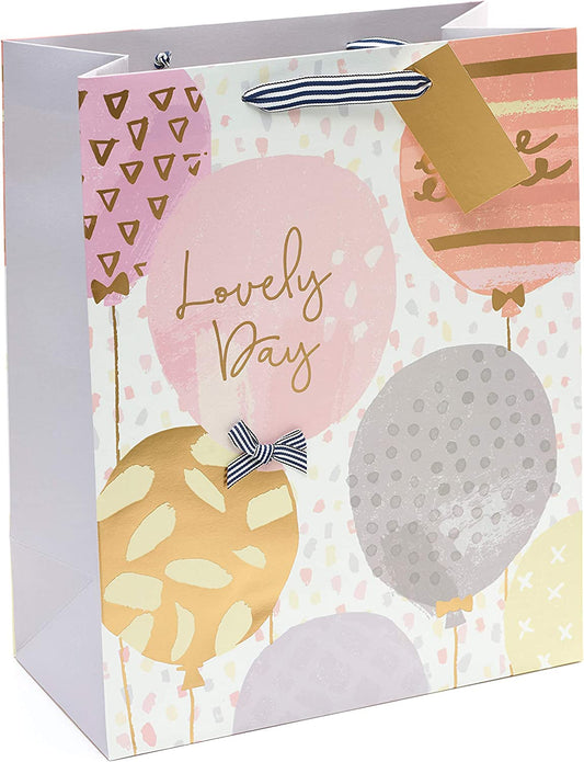 Large golden birthday gift bag from UK Greetings with balloon and greeting card design, perfect for celebratory gift presentation.