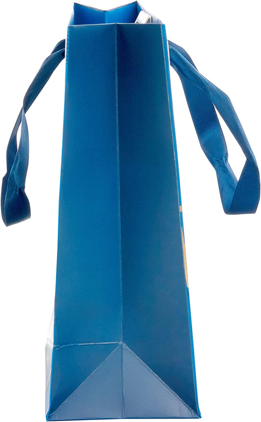 Medium blue UK Greetings gift bag with birthday lettering, featuring decorative designs and handles for gift presentation.
