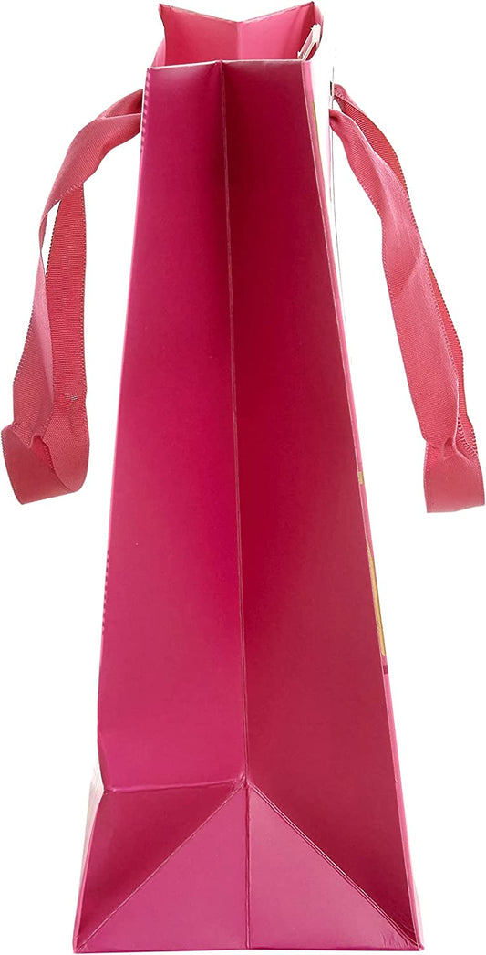 Medium pink greeting gift bag with birthday lettering from UK Greetings, featuring decorative design and handles.