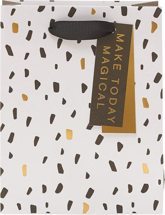 Elegant greeting card with modern design from UK Greetings, displayed alongside a stylish gift bag in a contemporary setting.