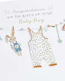 New baby boy greeting card featuring washing line design by UK Greetings, with colorful illustrations and cheerful message.