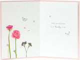 Pink floral flamingo greeting card with birthday message, featuring colorful floral and flamingo illustrations, by UK Greetings.