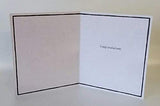 Close-up of a UK Greetings "So Proud of You" congratulations greeting card with colorful design and heartfelt message.