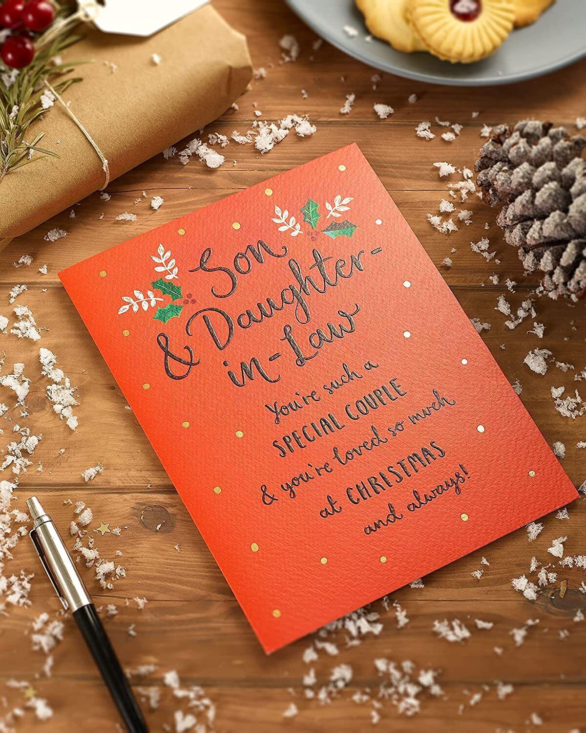 Christmas greeting card for son and daughter-in-law with typography design by UK Greetings, featuring festive holiday message.