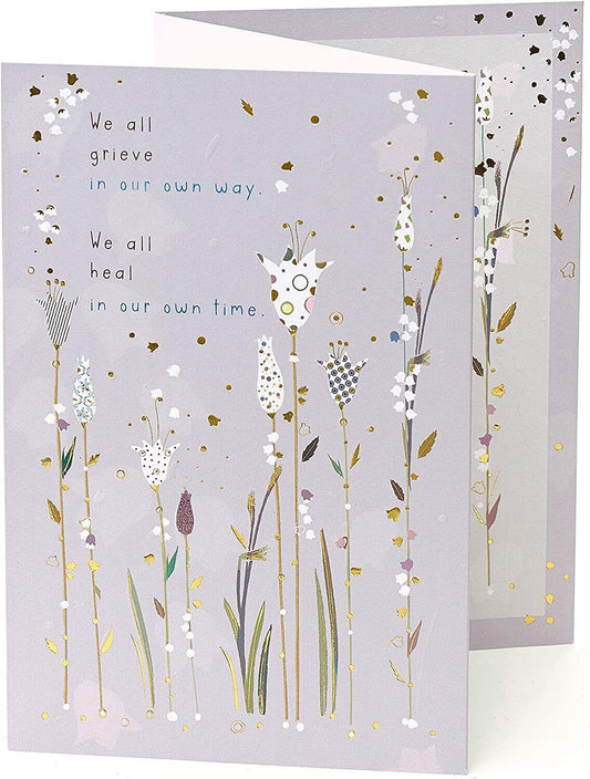 Gold foil sympathy greeting card titled "Caring Thoughts" by UK Greetings, featuring a comforting design for condolences.