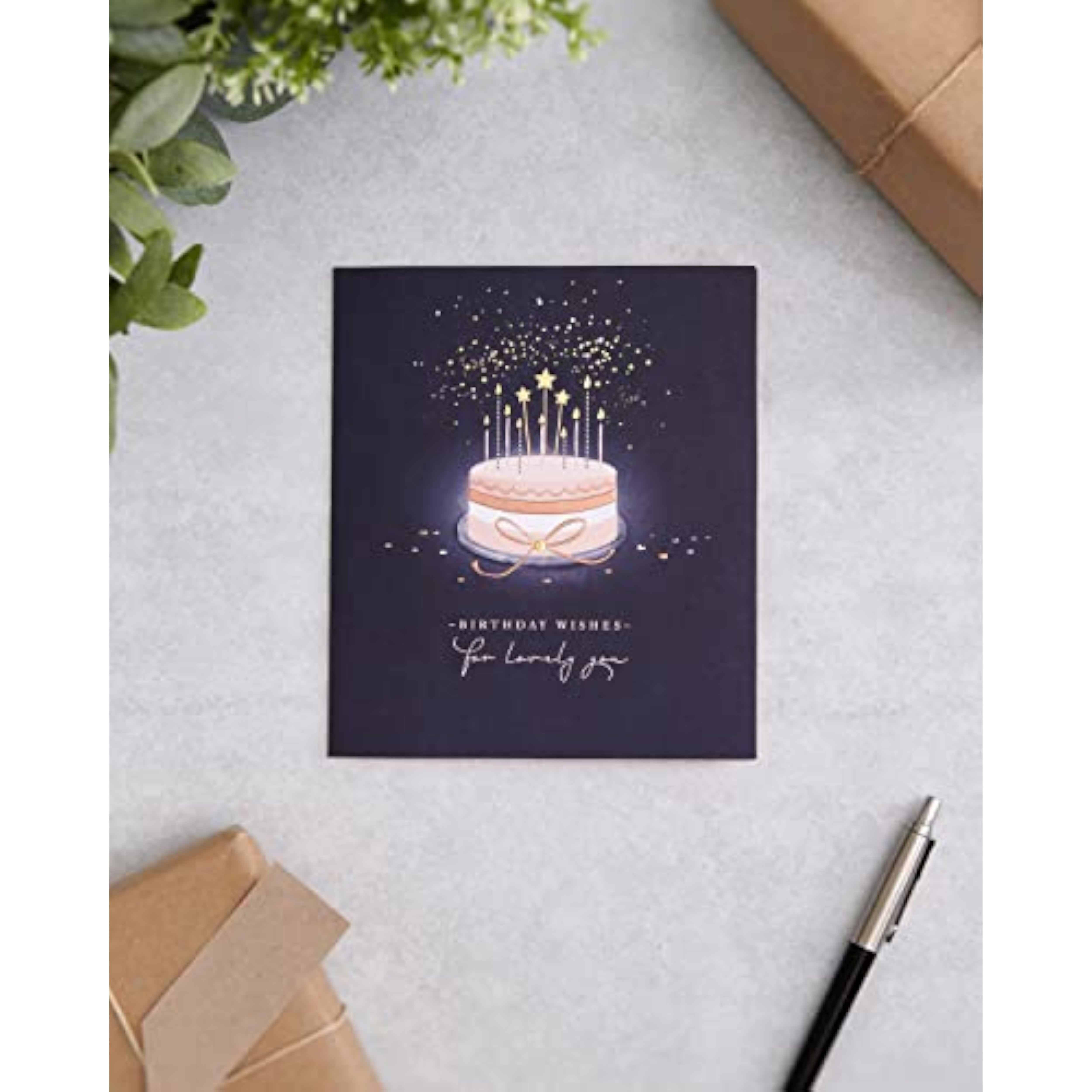 UKG birthday greeting card for her featuring a starry cake design and an envelope, perfect for celebrating special occasions.