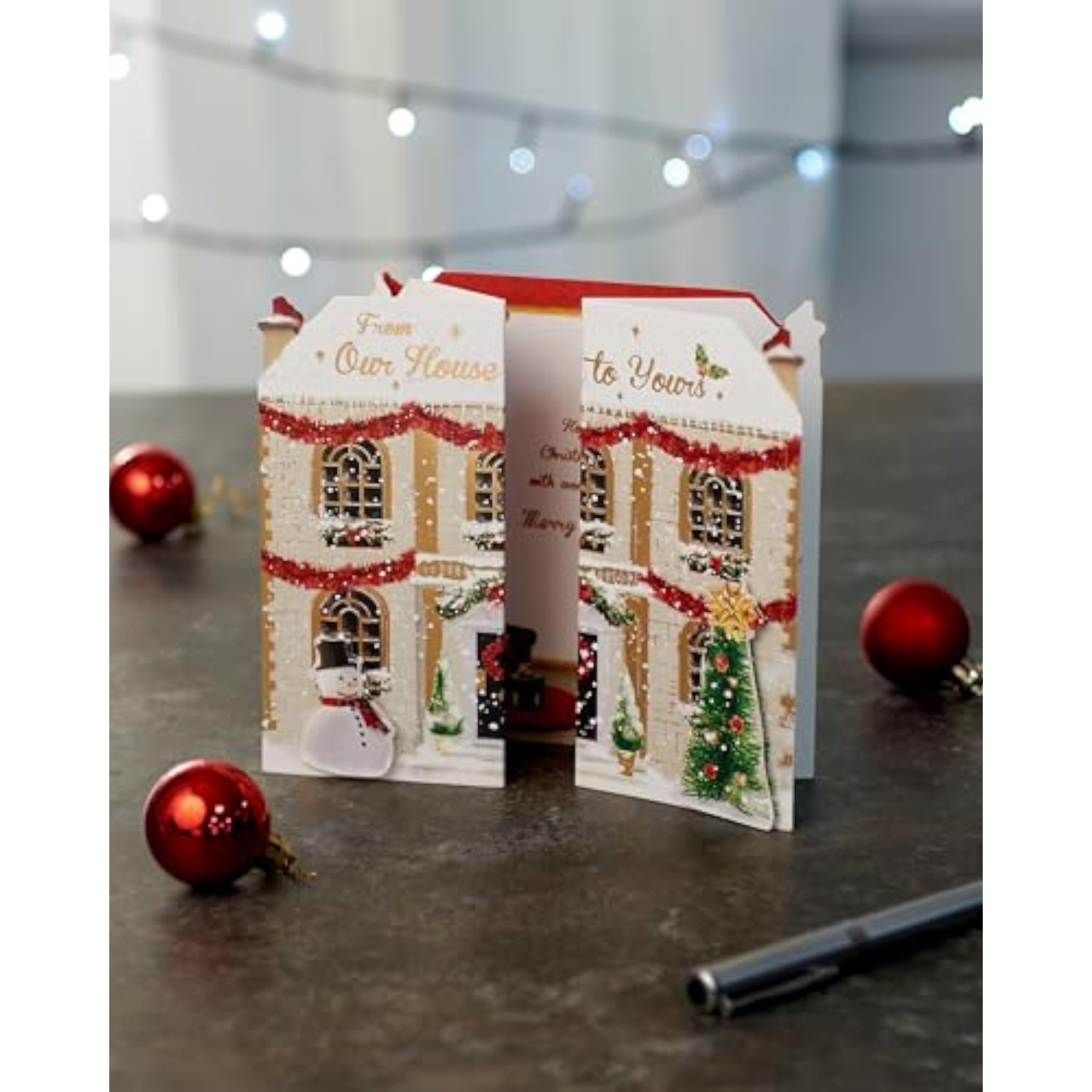 Festive 3D house-shaped Christmas greeting card for family from UKG, featuring colorful holiday design and festive details.