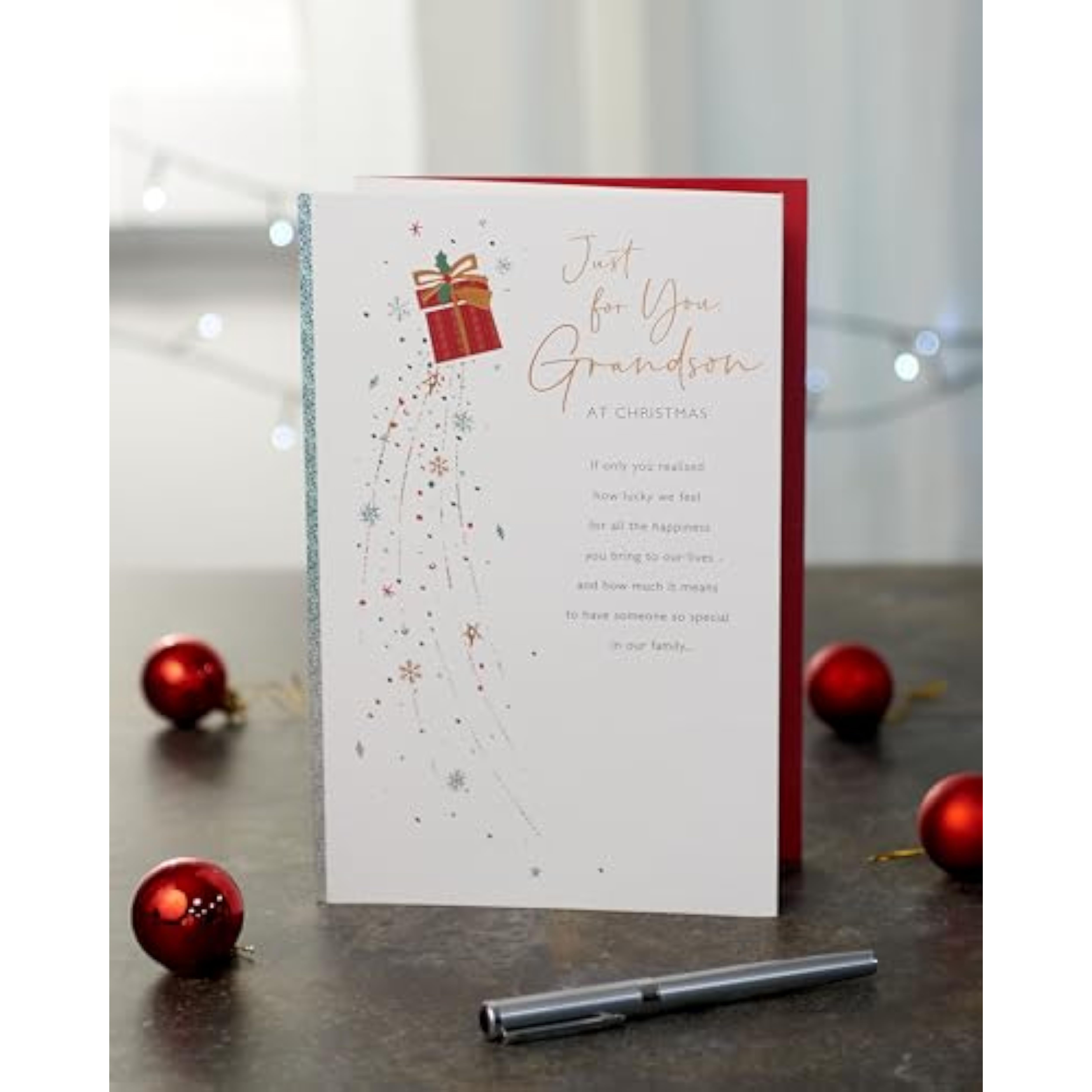UKG Grandson Christmas greeting card with snowflakes and present festive design, featuring colorful holiday illustrations.