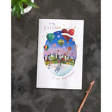 Colorful hot air balloon anniversary greeting card for husband by UKG, shown with envelope. Bright, cheerful design.