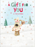 Boofle stood in snow holding present Christmas Card