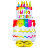 Colorful birthday cake foil balloon by Anagram, decorated with vibrant cake and candle illustrations for celebration.