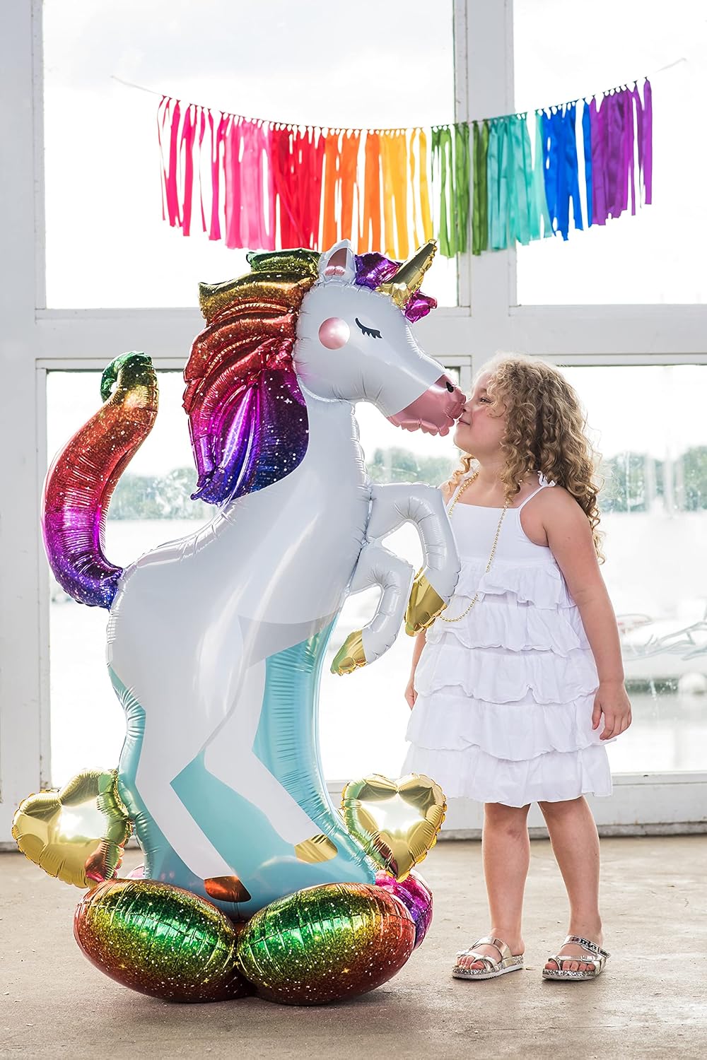 Pink unicorn foil balloon with multicolored details, featuring a festive design, from Anagram.