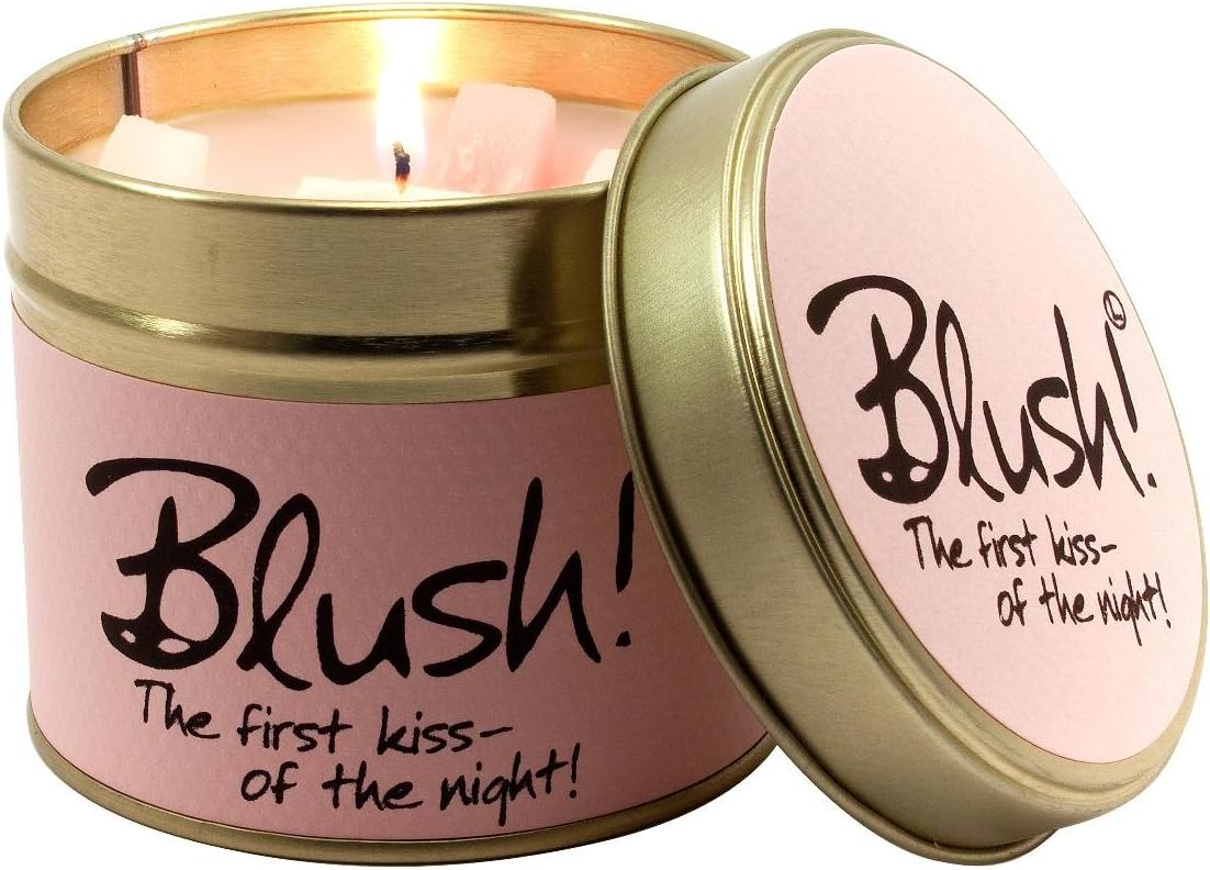 Lily-Flame blush scented tin candle with floral design, showing the candle inside the decorative metal tin.