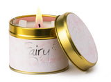 Lily-Flame Fairy Dust scented tin candle with colorful fairy dust design and a silver lid, perfect for adding charm to any space