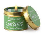 Lily-Flame Freshly Cut Grass scented tin candle with a green label and metallic lid, ideal for fresh outdoor fragrance.