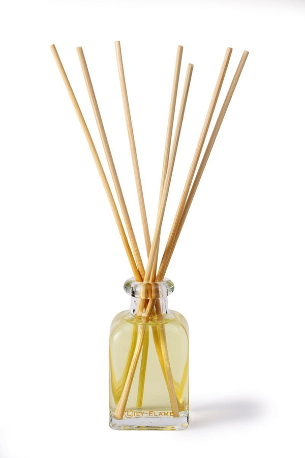 Lily-Flame reed diffuser refills with natural reed sticks for aromatic home fragrance, arranged in a clear container.