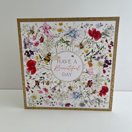 Gold foil Wildflower Bloom birthday greeting card by NQ with colorful floral design and elegant lettering.