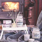 Large Magnolia scented candle jar by Price's Candle with a clear glass container and a white wax top.