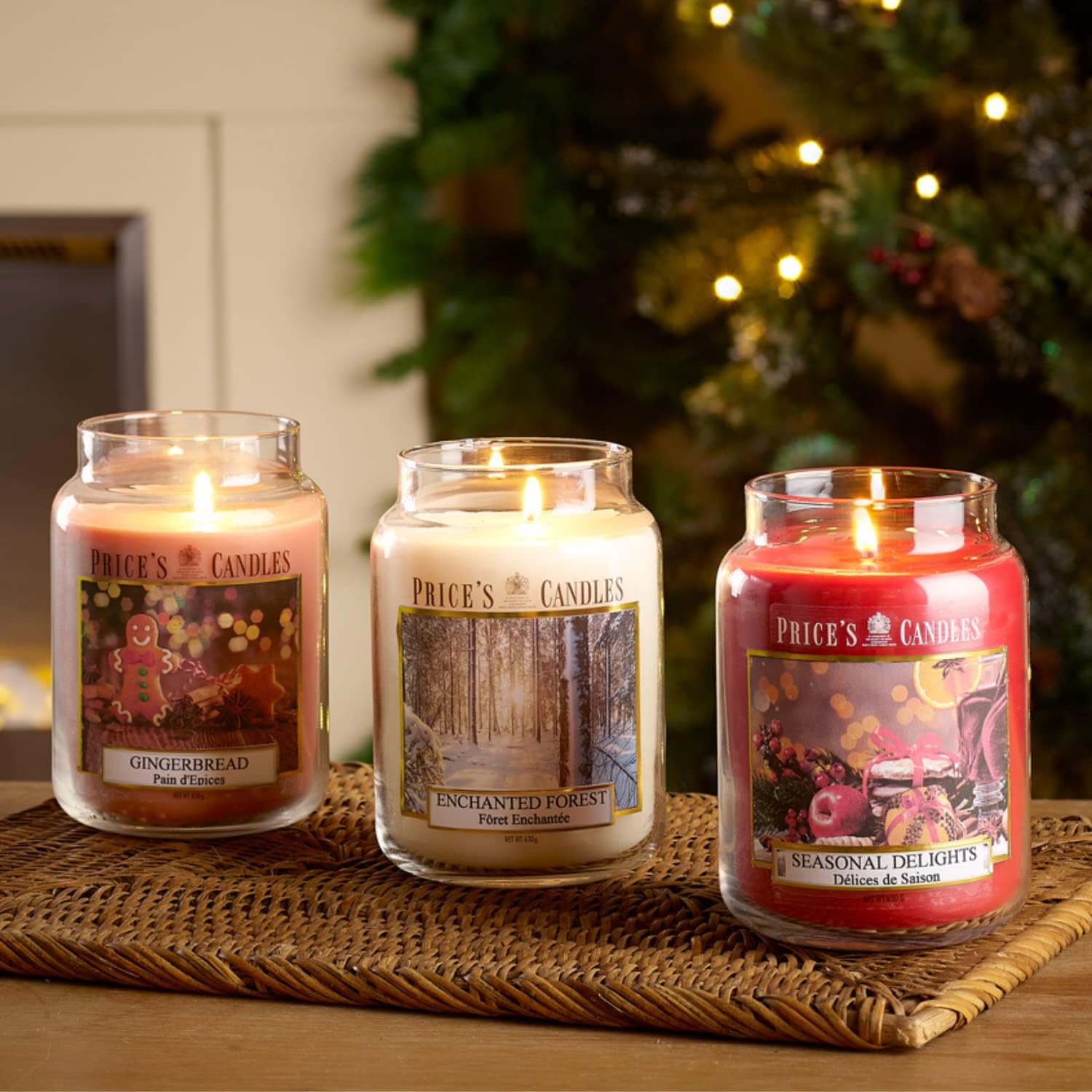 Large glass jar candle with a magnolia fragrance from Price's Candle, featuring a clear container and a lit wick.