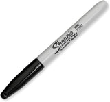 Sharpie black permanent marker fine point next to a greeting card, showcasing its precise tip for detailed writing or decorating.