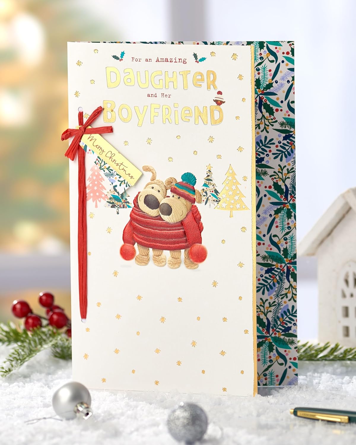 Cute Boofle Christmas greeting card from UK Greetings featuring a cuddly daughter and her boyfriend with festive embellishments.