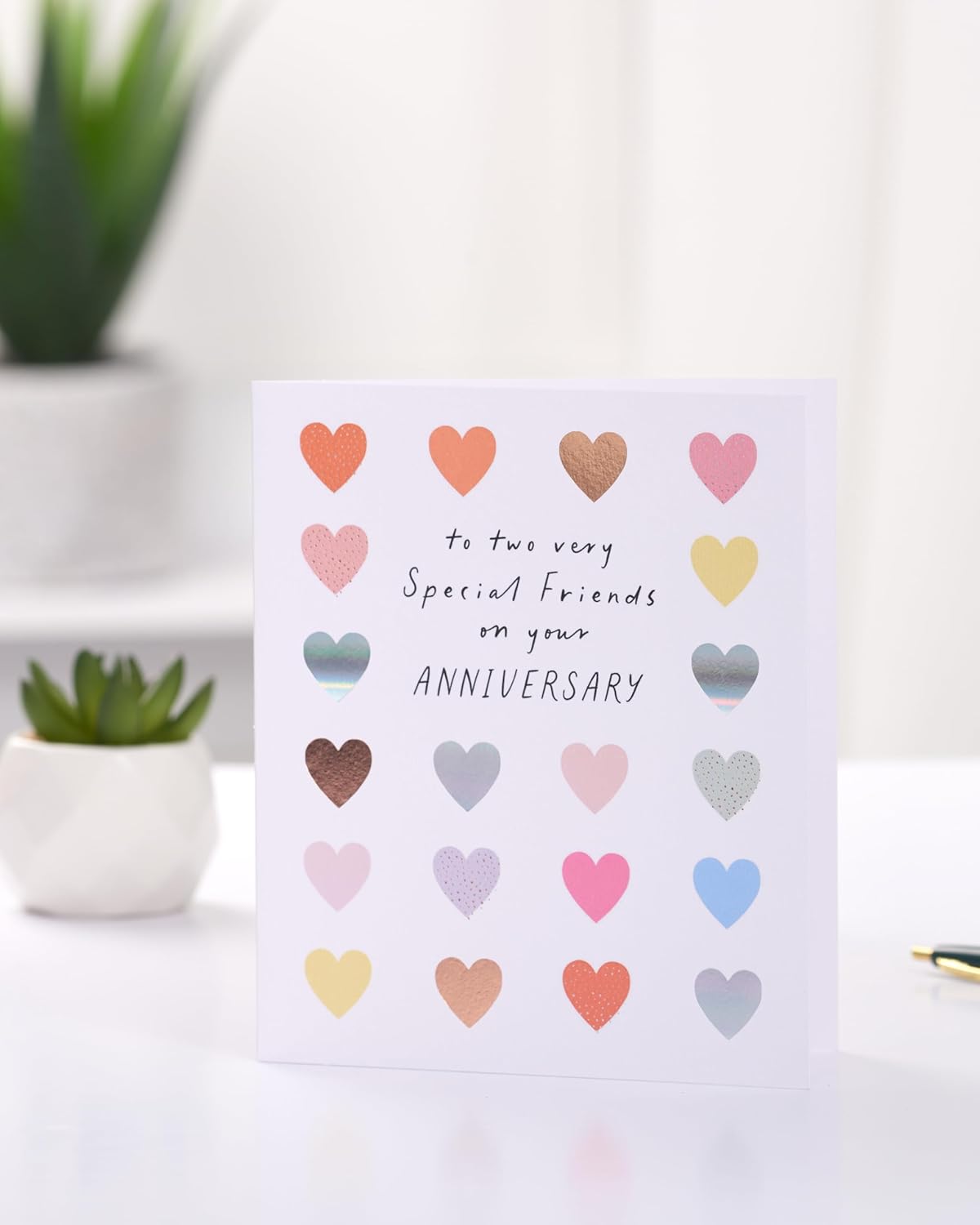 Colorful hearts design anniversary card for friends, featuring bright and loving greeting by UK Greetings.