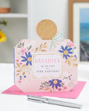 UK Greetings birthday card for daughter featuring a perfume bottle-shaped design with floral accents and colorful illustrations.