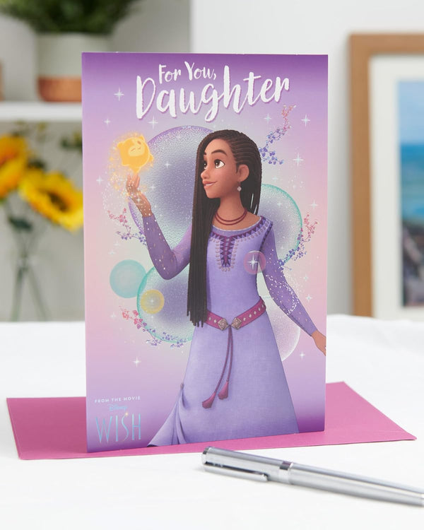 UK Greetings Disney Wish birthday card for daughter featuring Asha design with colorful Disney characters and festive artwork.