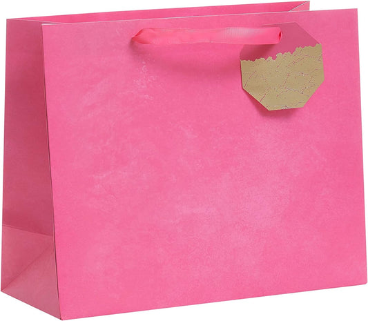 Large bright pink gift bag with floral design, perfect for all occasions, by UK Greetings, suitable for gift packaging.